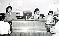 Charles Harris, left, First State Bank teller